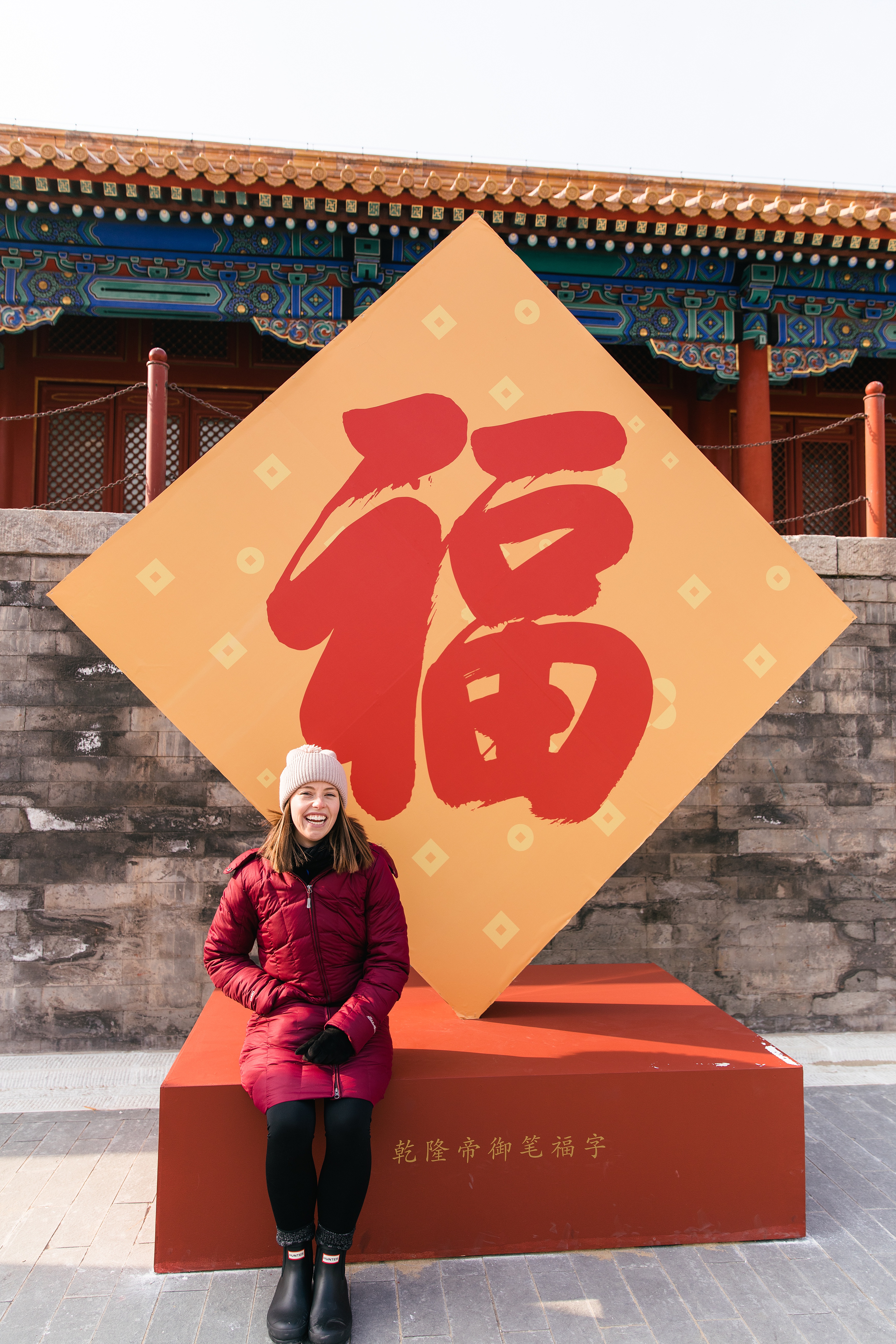 girl in front of Chinese sign