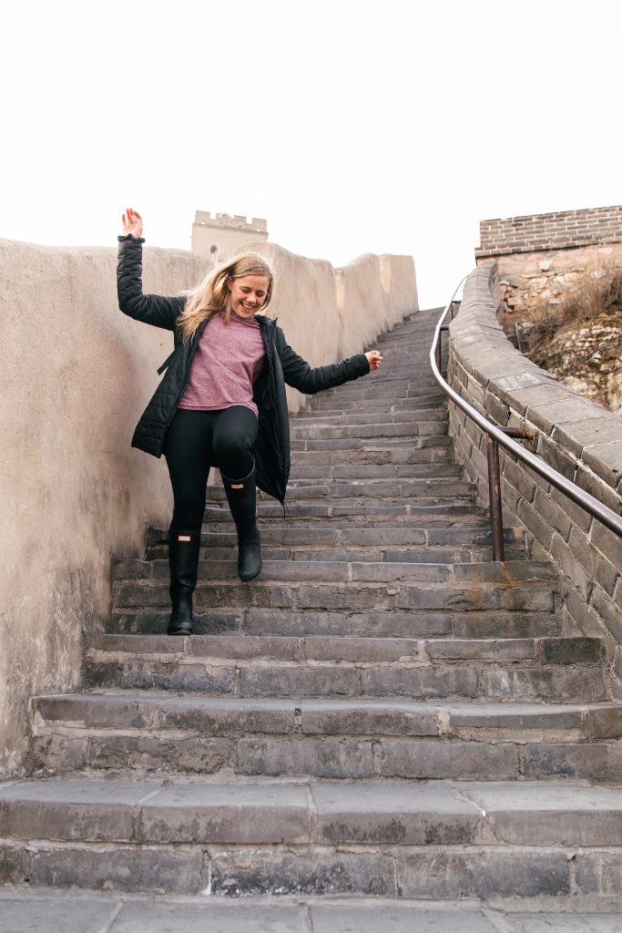 girl running down the Great Wall of China