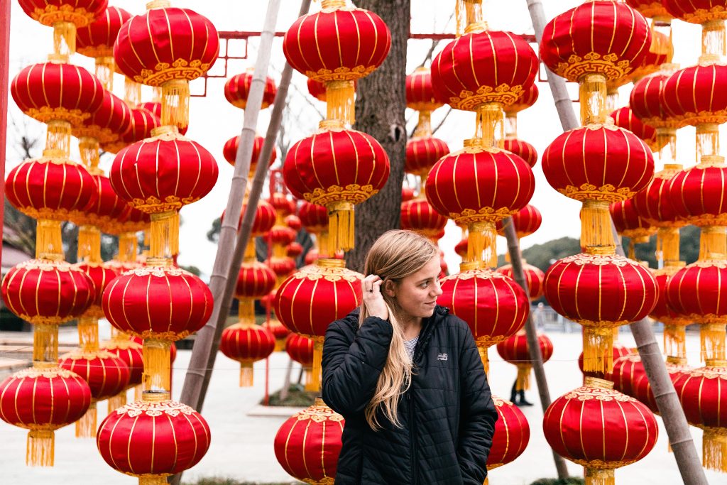 girl standing in front of Chinese lanterns