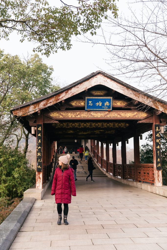 girl walking on Chinese bridge