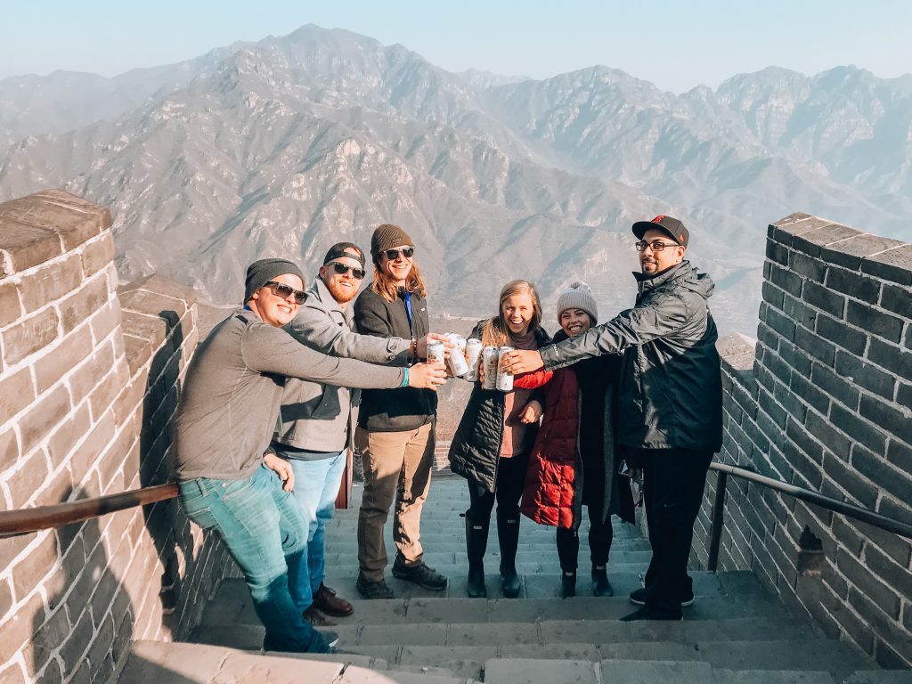 group drinking beer at the Great Wall of China
