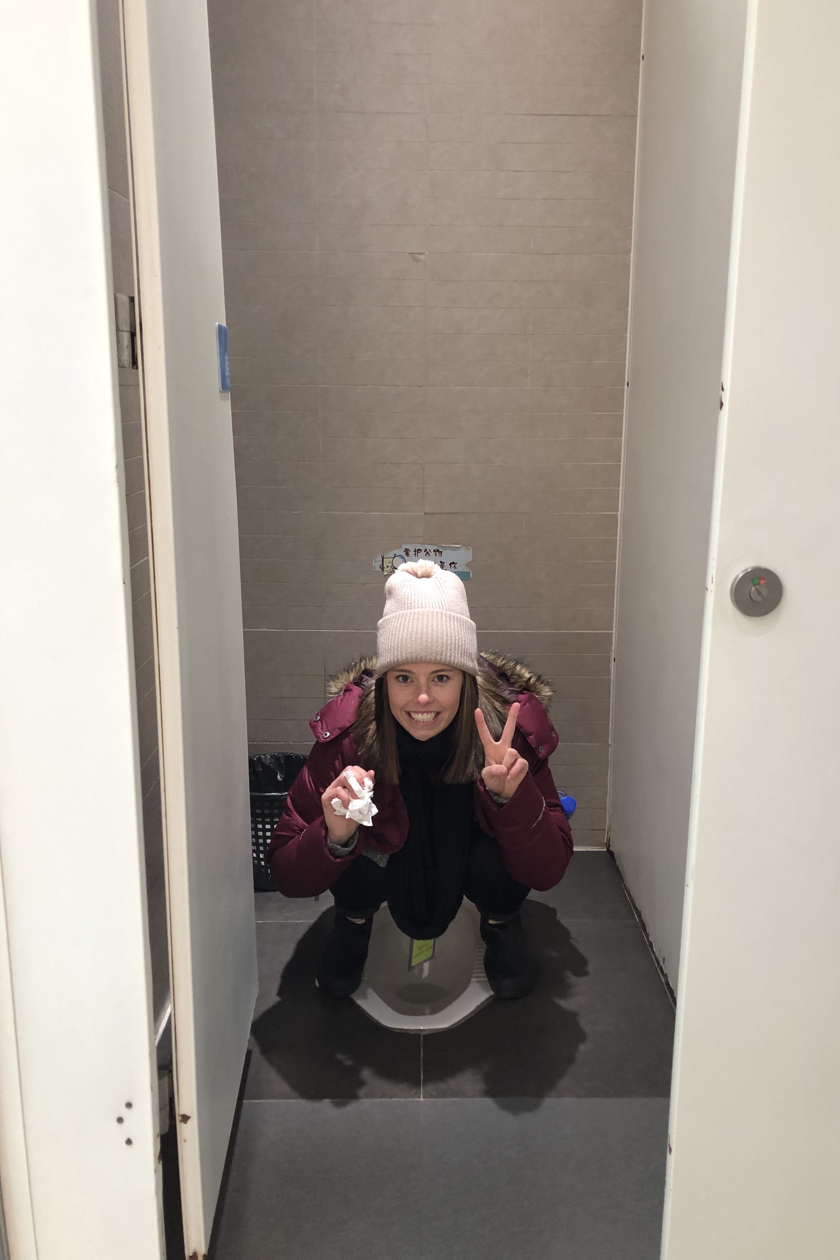 girl using a Chinese toilet