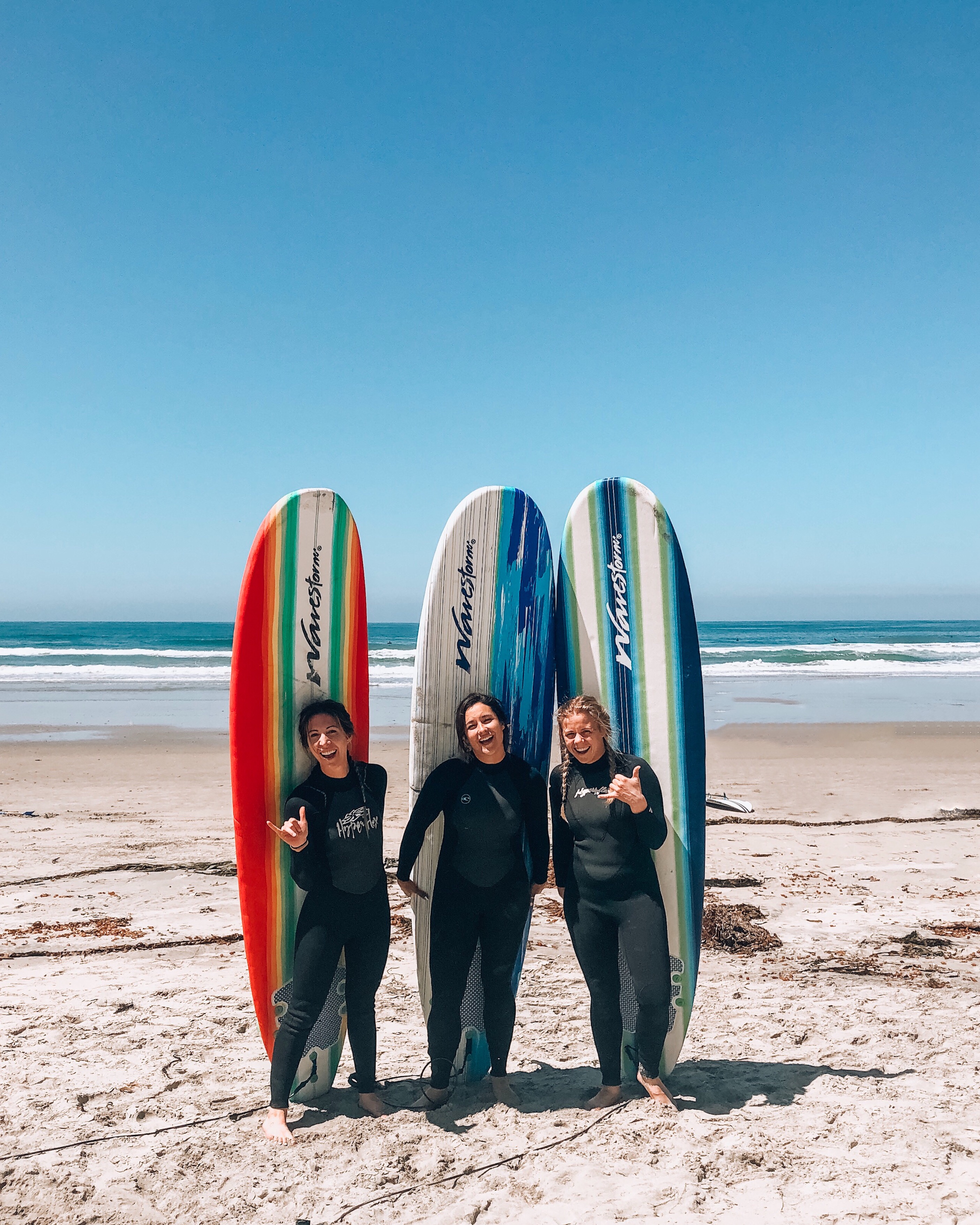3 women with surfboards in Pacific Beach San Diego